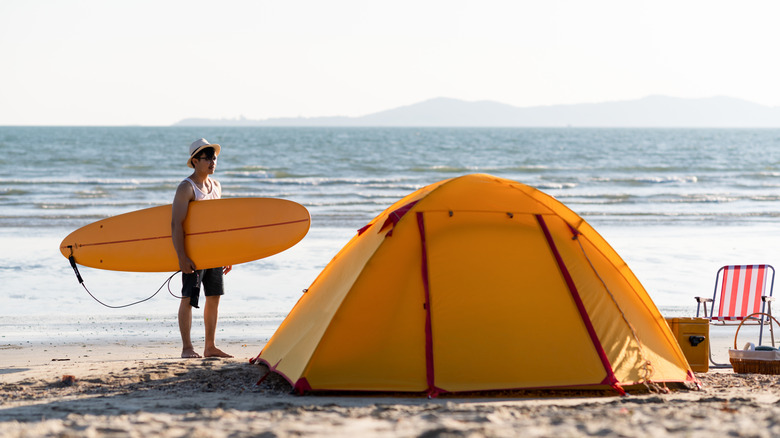 Surfer with beach tent 