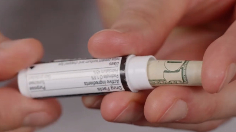 sliding cash into lip balm