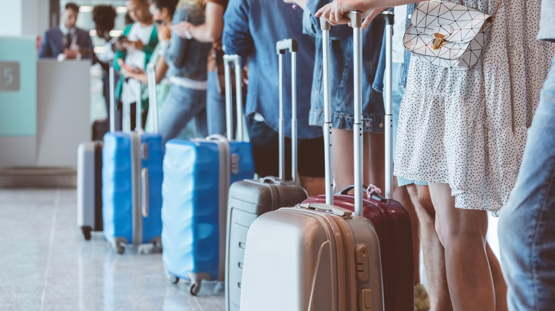 Passengers lining up to board a plane