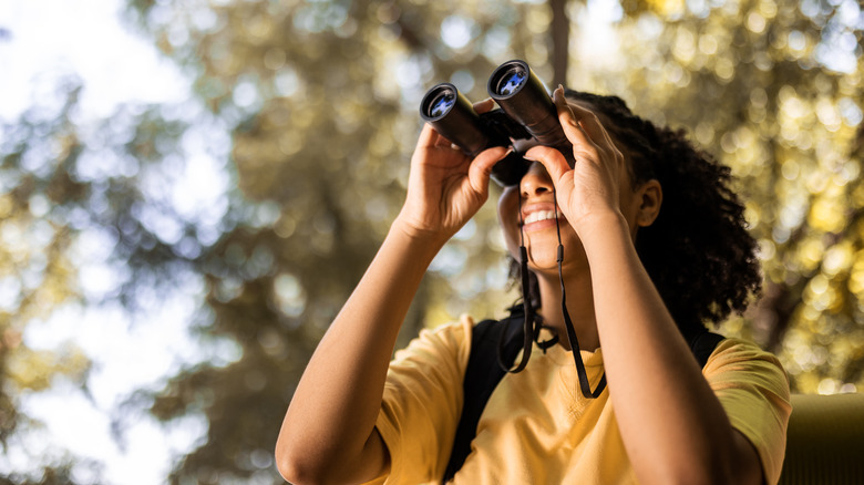 A woman using binoculars