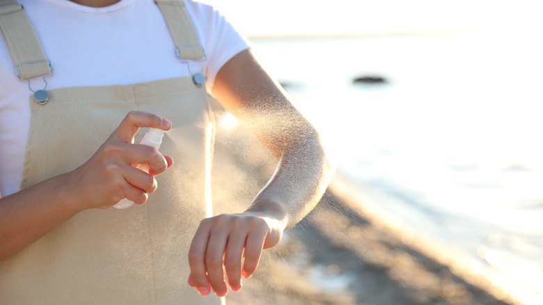 Using bug spray at beach