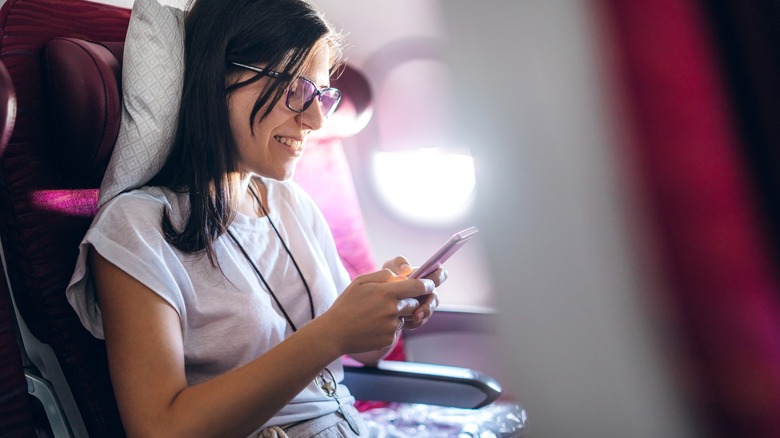 Girl uses airline pillow