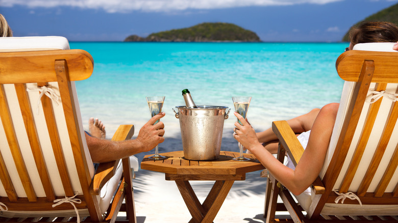 Couple drinking Champagne on beach