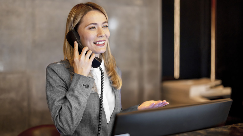 smiling hotel employee on phone