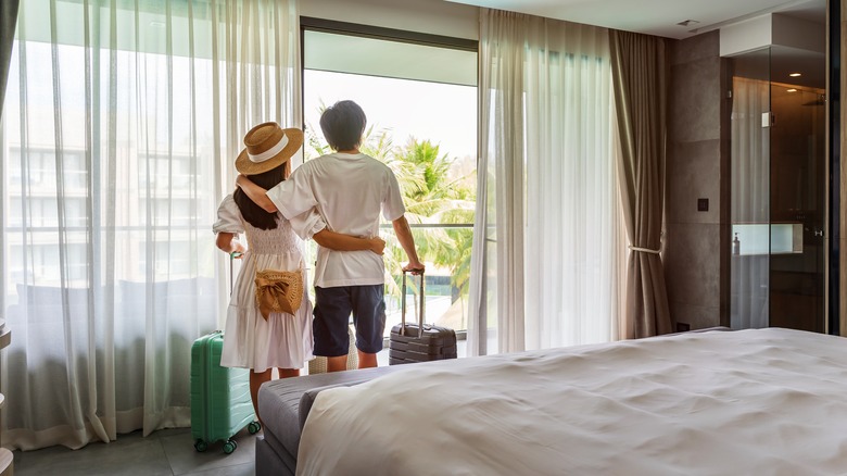 couple looks out resort window