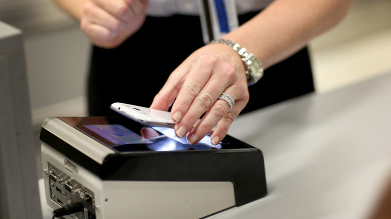 Person scanning phone at MBC kiosk