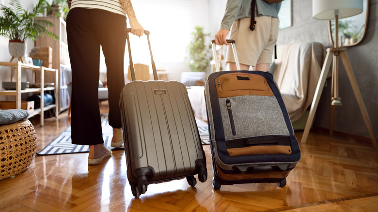 Two people checking into their accommodation