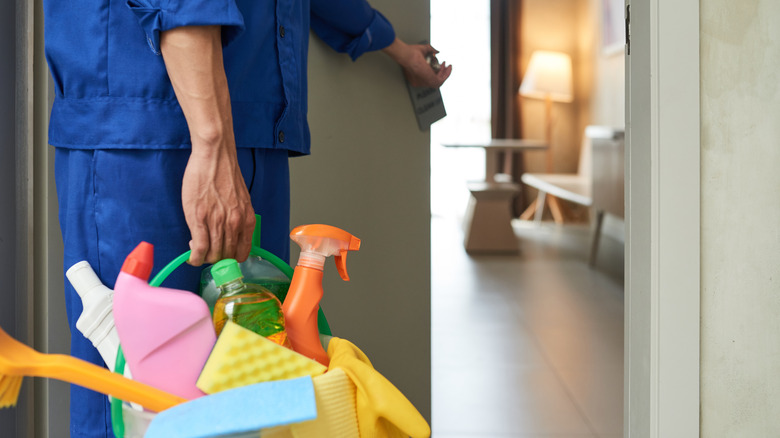 Hotel housekeeper opening a room