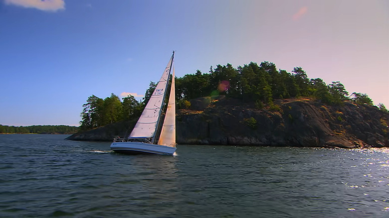 Boat sailing around green island