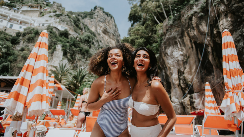 two women smiling on beach