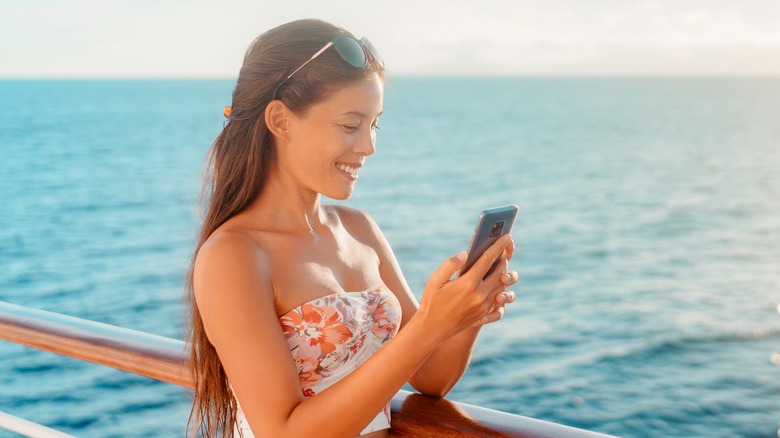 Woman using phone on cruise