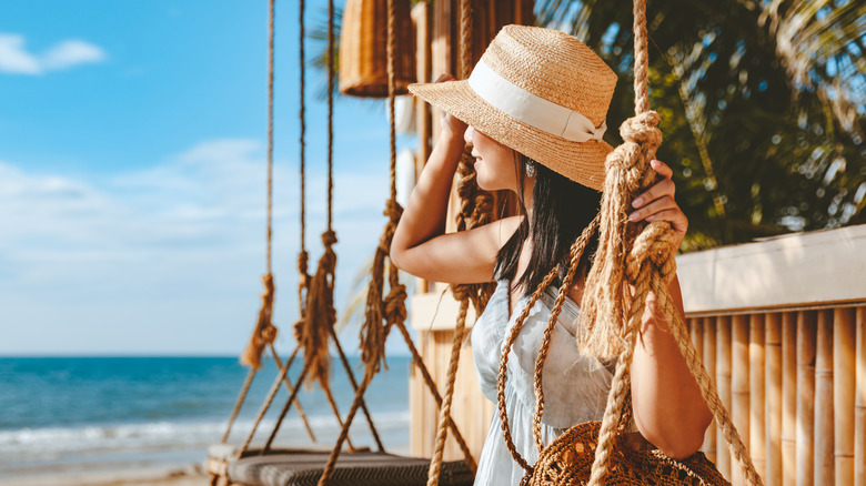 woman on swing on beach