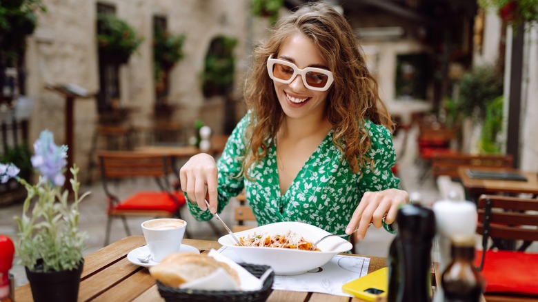 A woman eating pasta