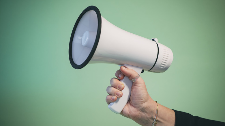 Hand holding a megaphone