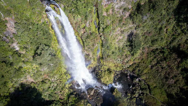 Waterfall down mountain with greenery