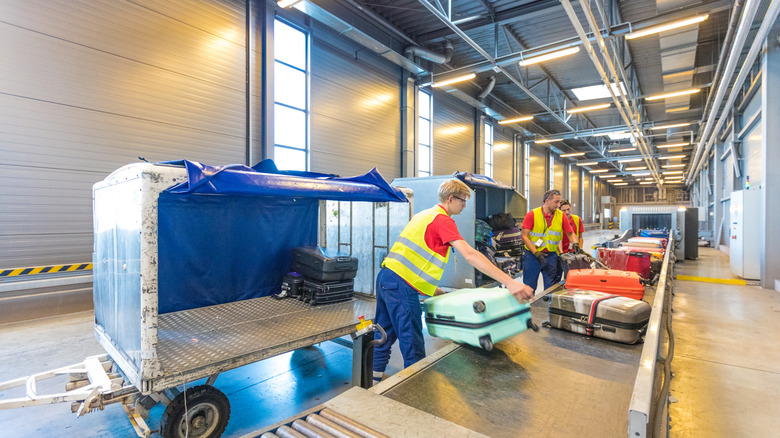 Airport staff loading baggage