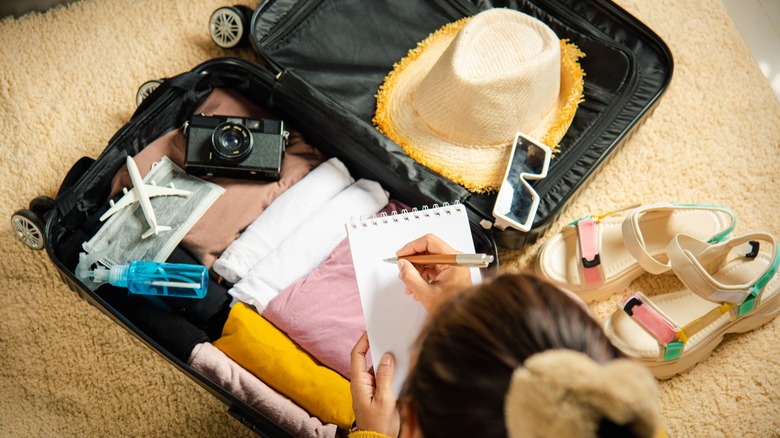 Woman packing suitcase