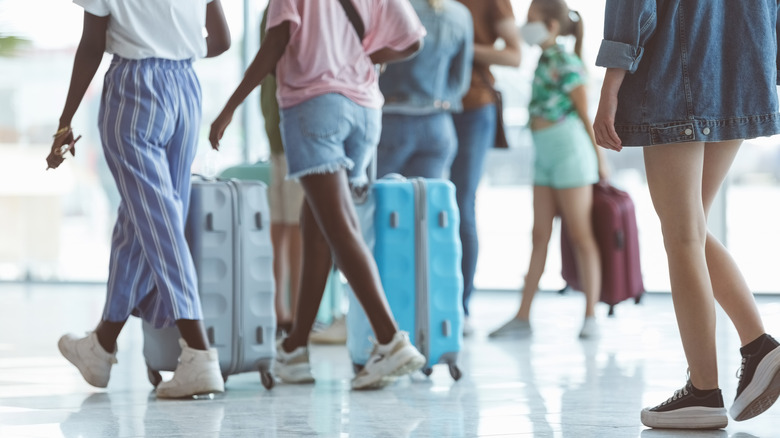 People walking in shorts at the airport 