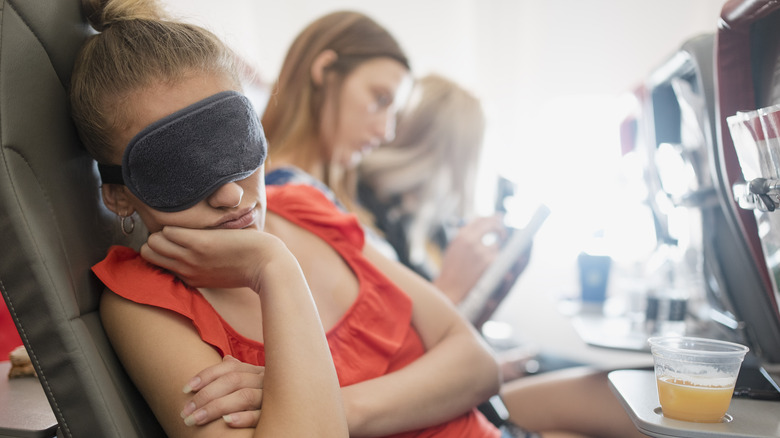 Woman sleeping on flight