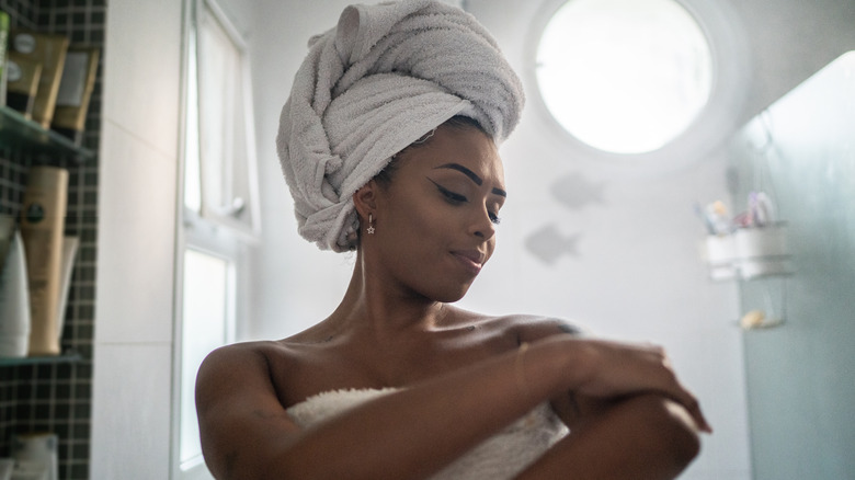 Woman checks skin after shower