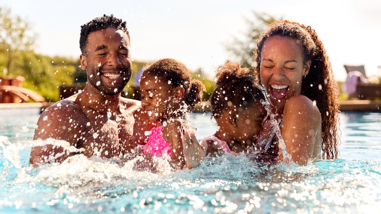 Family splashing in pool