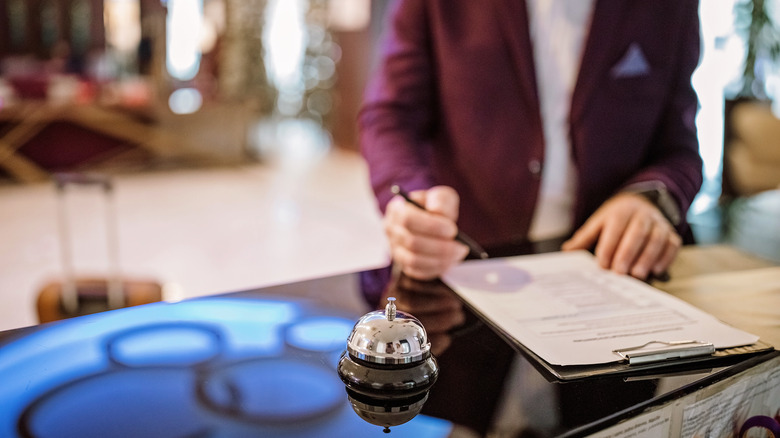 a hotel guest looks over their bill