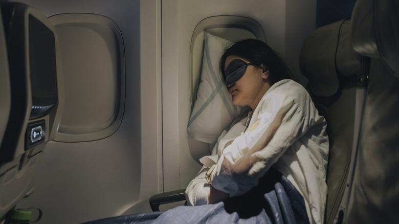 Woman sleeping in window seat