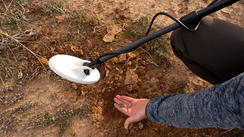 Metal detectorist holding coins