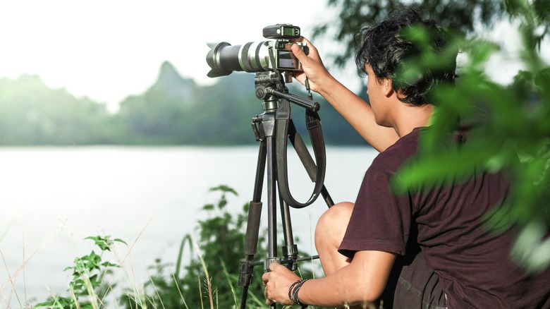 Man setting up camera on tripod