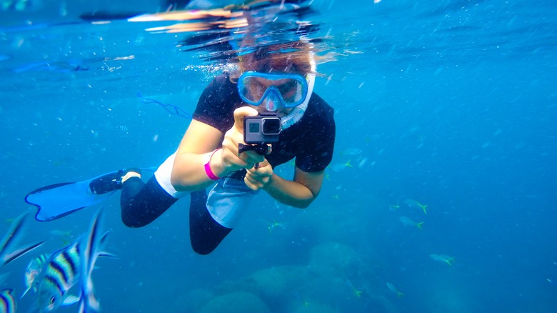 Person using GoPro underwater 