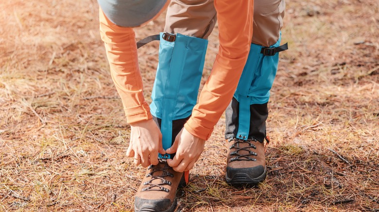 Man pulls gaiters over shoes