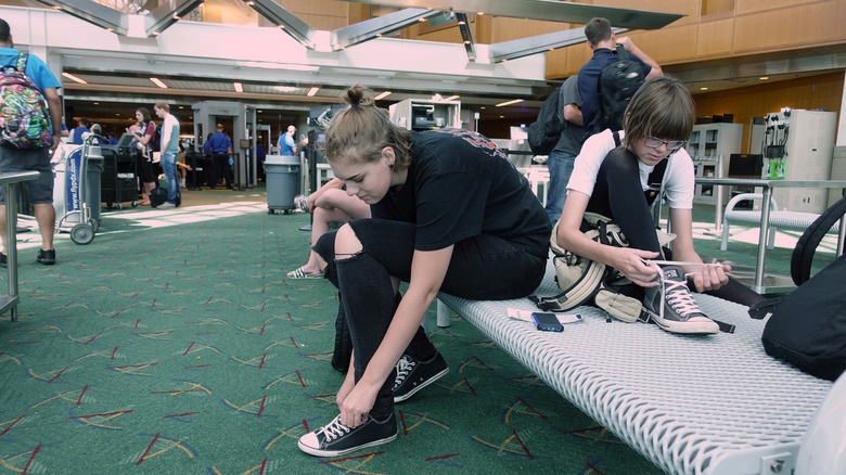 Air passengers putting on shoes