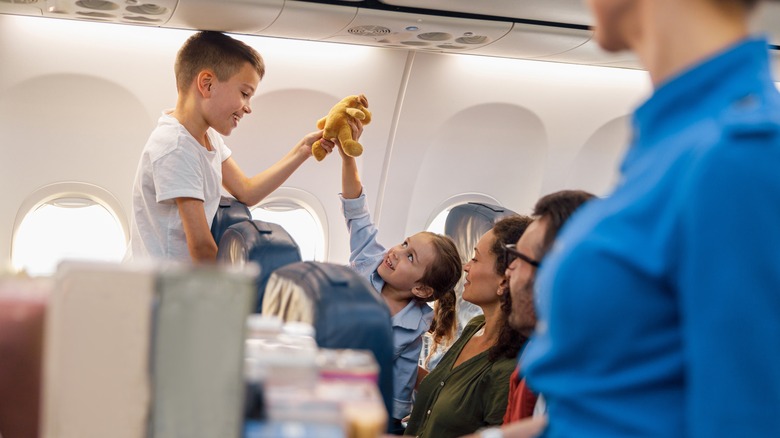 Family sitting apart on plane